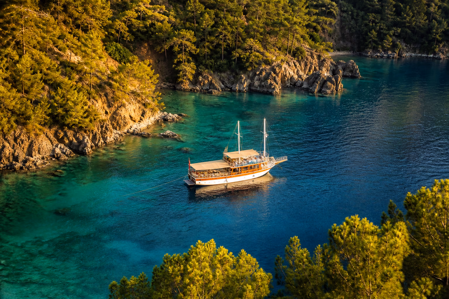 Aerial view of the Aegean coastline near a secluded turquoise bay